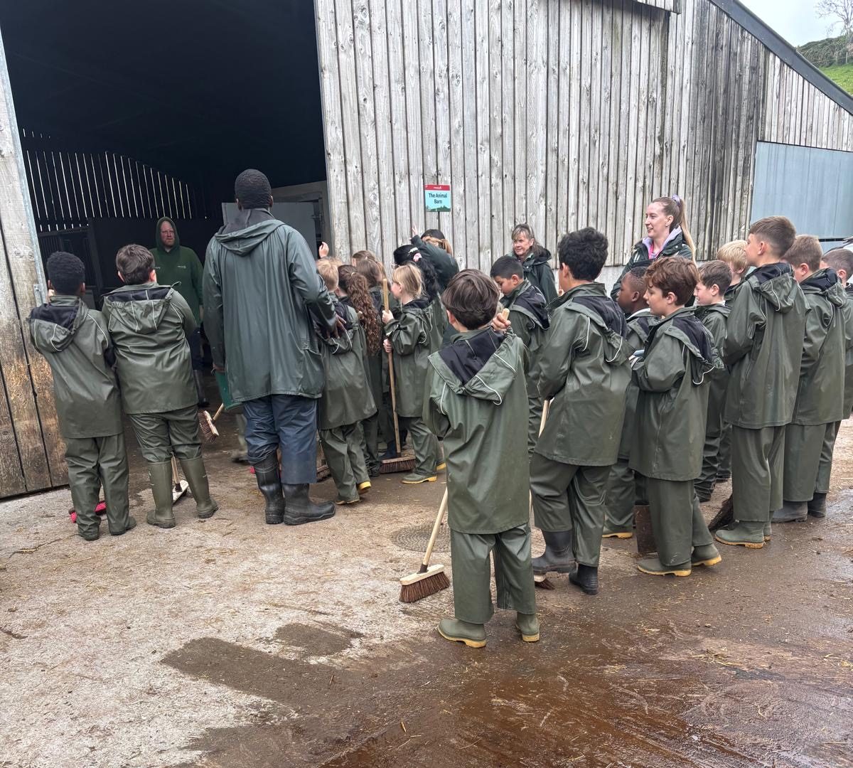 Children gathered around pig shed